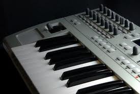 A MIDI keyboard connects to a computer for recording music.